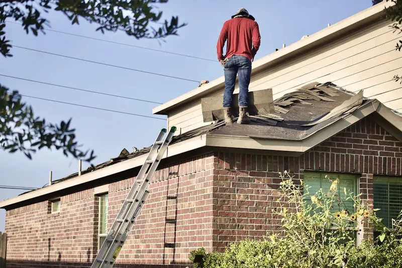 Professional roofer working on a residential roof in Arlington Park